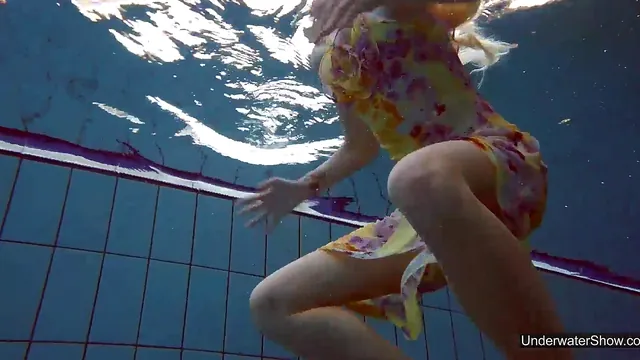 Milana Voda, a petite teen, goes for a naked swim in the pool