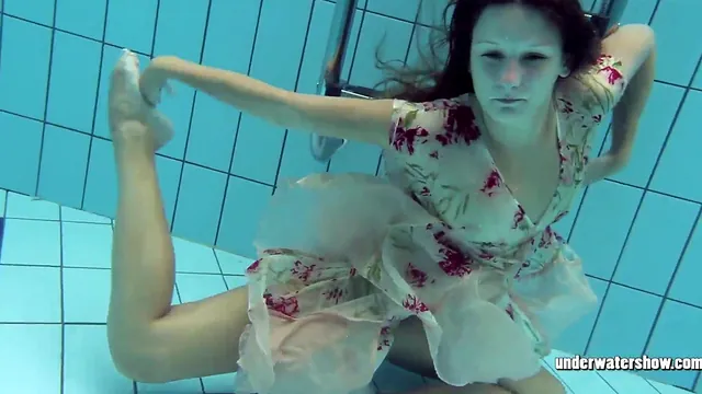 Blonde Lucy goes for a naked swim in the pool