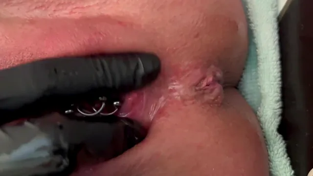 Aqua Pola in latex gloves sends a strong stream of pee from a pierced pussy
